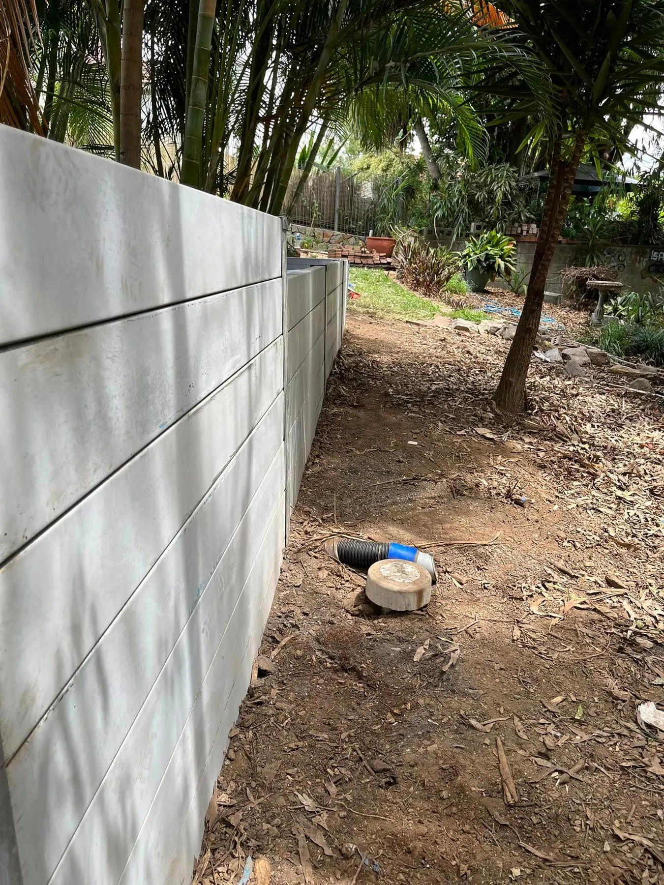 Tall grey concrete sleeper retaining wall panels